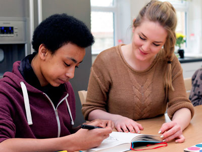 Child holding balloon in field